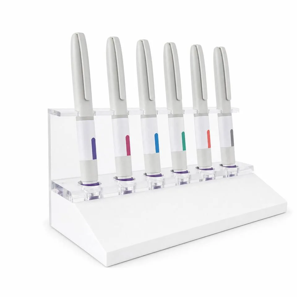 1:1 injection pen display set in resin on a white wedge base with a clear acrylic holder